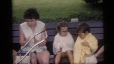 1954: Four Young Boys with a Baby and a Lady Sitting on a Bench Pennington