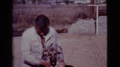 1968: Smoking Man Giving His Puppy a Bath Outside in the Backyard