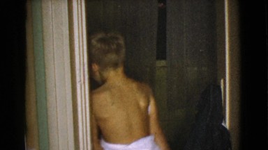 1968: Shy Boy Partially Covered in Towel Hides Behind Door Cottonwood
