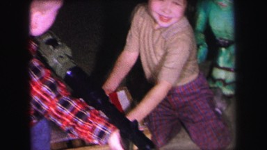 1972: Two Young Children Playing Indoors with Toys, Boy with Toy Gun