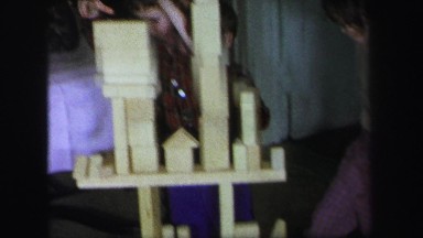 1972: children playing and stacking various wooden blocks on the floor LYNBROOK,