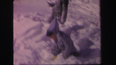 1972: two children in coats run through snow while one child scoots LYNBROOK,