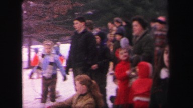 1972: crowds of people sledding down a hill covered with snow during winter.