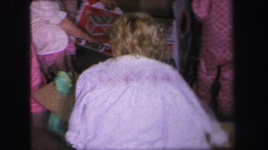 1972: a family with small children opening presents in their pajamas on