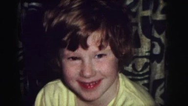 1974: several children, mostly wearing yellow pajamas, play on new toys