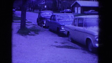 1964: cars are parked along roadside in night near to buildings NIAGRA FALLS