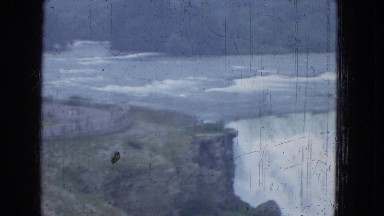1964: people on the viewing area of a large waterfall enjoying the breeze