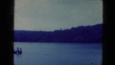 1964: an around view of a beautiful lake and mountain on background