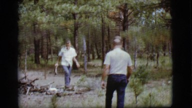 1968: two men collecting firewood in the woods by a road COTTONWOOD, ARIZONA
