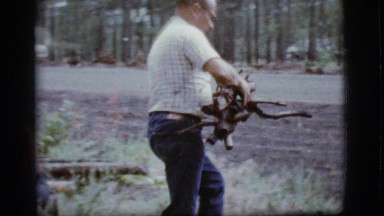 1968: the old man gathered some wooden sticks and carrying through the car