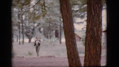1968: a woman goes for a stroll and waves at the camera COTTONWOOD, ARIZONA