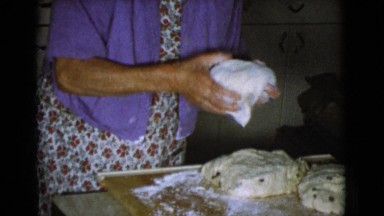 1968: two old woman with balls of dough to make a dish in the kitchen