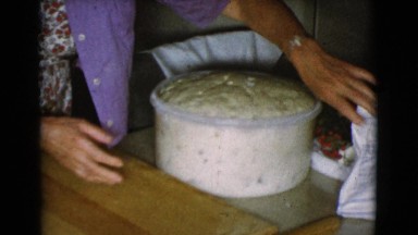 1968: grandmother in kitchen preparing to knead dough for baking COTTONWOOD,