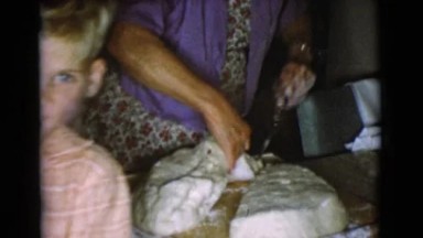 1968: a woman working in the kitchen, cutting bread dough COTTONWOOD, ARIZONA