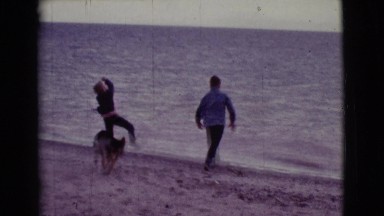 1968: two young lads frolicking at the beach with pet COTTONWOOD, ARIZONA