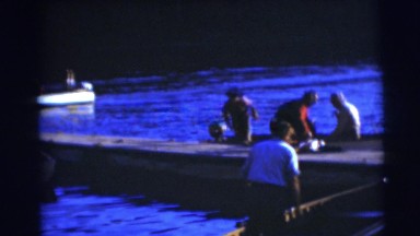 1953: Several Men Work Around Boats in a Small Wisconsin Harbor