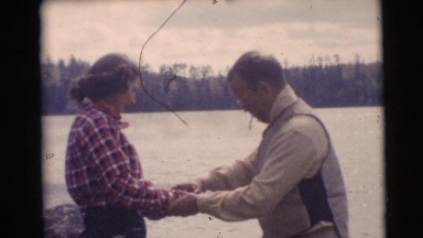 1953: Man Teaching Young Woman How to Cast Fishing Line in Wisconsin