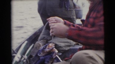1953: a man in a boat in the lake with a big catch of fishes WISCONSIN