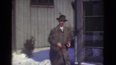 1939: man off to work, what a gentleman. look at those cars! LOS ANGELES,