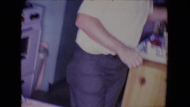 1961: middle aged couple cooking in the kitchen SALTON SEA, CALIFORNIA