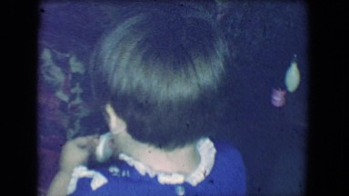 1961: Christmas Tree Stands in Background and Children Gather Around