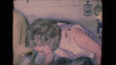 1961: party of children gathered around a dining table, enjoying plates