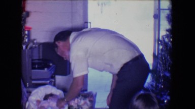 1961: new born baby in carrier is being introduced to the relatives