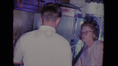 1961: older female with cat-eye glasses and younger man and woman, sharing