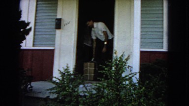 1966: man moving a box out of a house SAN PEDRO, CALIFORNIA