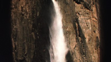 1969: water falls down brown wall of rocks in a spray of foam and mist YOSEMITE,