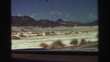 1969: Automobile Traveling Along Paved Road Entering Death Valley Yosemite