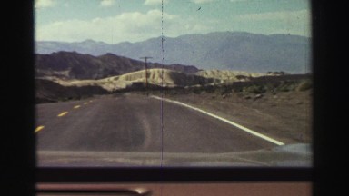 1969: moving vehicle through a deserted highway amid mountains YOSEMITE,