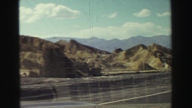 1969: a hilly area is seen with a car YOSEMITE, CALIFORNIA