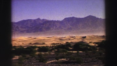 1969: a beautiful desert and rugged mountain ridgeline with a bright blue sky
