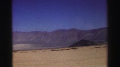 1969: a fast moving vehicle travels by a majestic scene of nature at it's best.