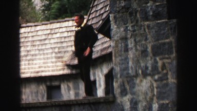 1969: a man jumps to the road from the rock wall and walks away YOSEMITE,