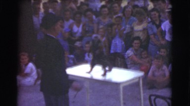 1951: small monkey performing for crowd CANADA