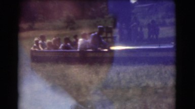 1951: children riding a miniature train in a field during the summer