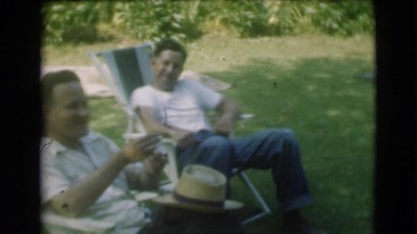 1951: two men sitting in a backyard enjoying a conversation CANADA