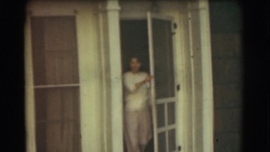 1951: woman exits house and smiles CANADA