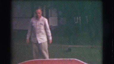1951: man walks off smiling and waving to camera