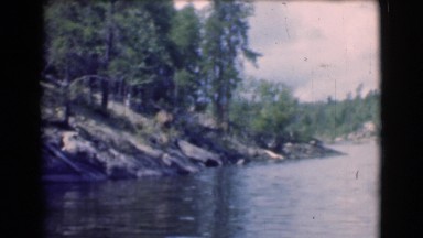 1951: mountain forest sitting beside a lake. CANADA