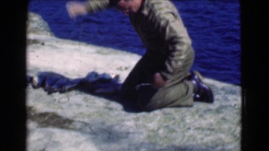 1951: a man on the seashore displays a group of freshly caught fishes CANADA