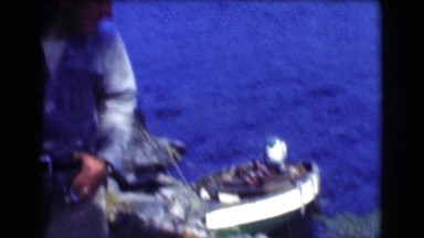 1951: blue water-body with banks rich in trees seen from a moving boat CANADA