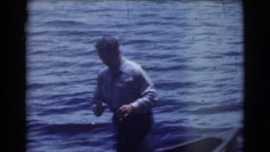 1951: the man trying his fishing skills in the river on the boat CANADA