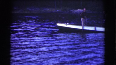 1951: two men fishing on a small boat in a lake CANADA