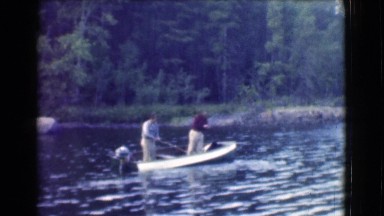 1951: two men fishing in a small boat in a river in the forest CANADA