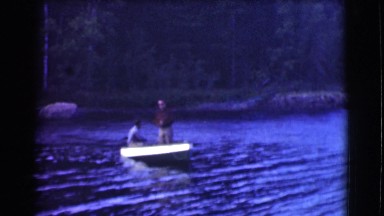 1951: two men going out on the lake in a boat ready to catch some big fish
