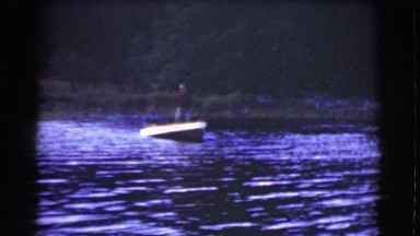 1951: two old men in a small boat fishing on a lake catching nothing CANADA