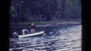 1951: a shirt shirt man is is fishing from a river CANADA